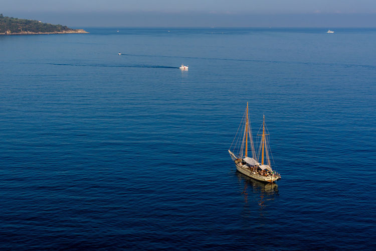 High angle view of sailboat on blue sea