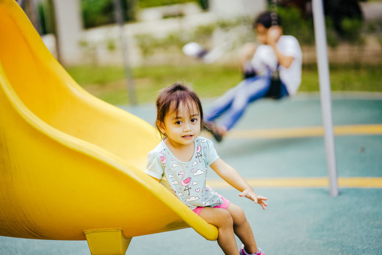 Portrait of girl playing on slide