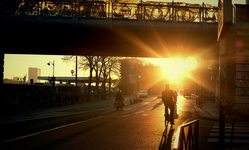 People on road at sunset