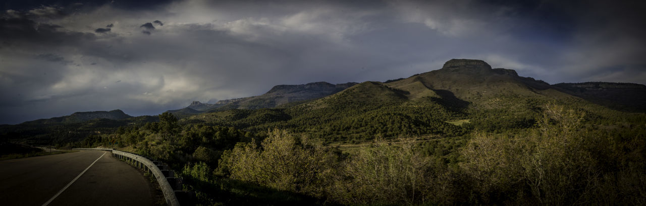 Road by mountain against sky