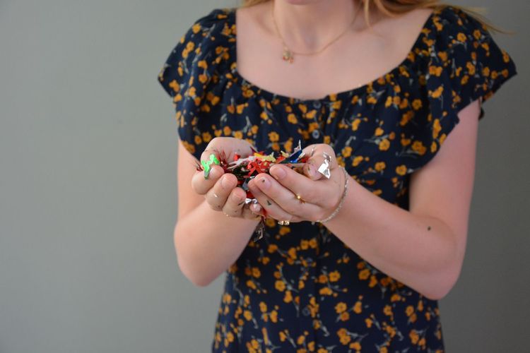 Midsection of woman holding confetti