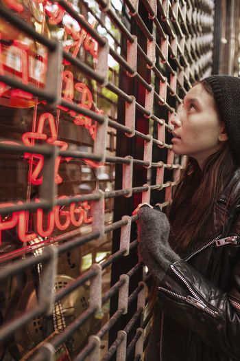 Young woman looking into a closed store