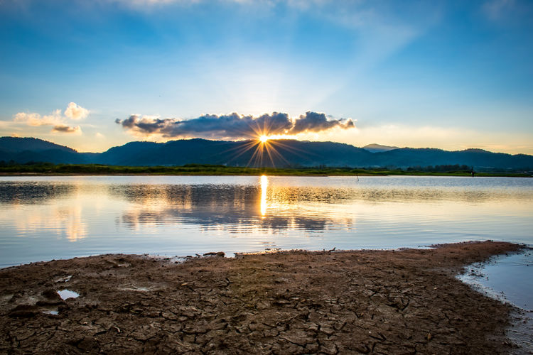 Scenic view of lake against sky during sunset