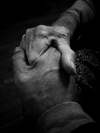 Cropped image of senior couple holding hands