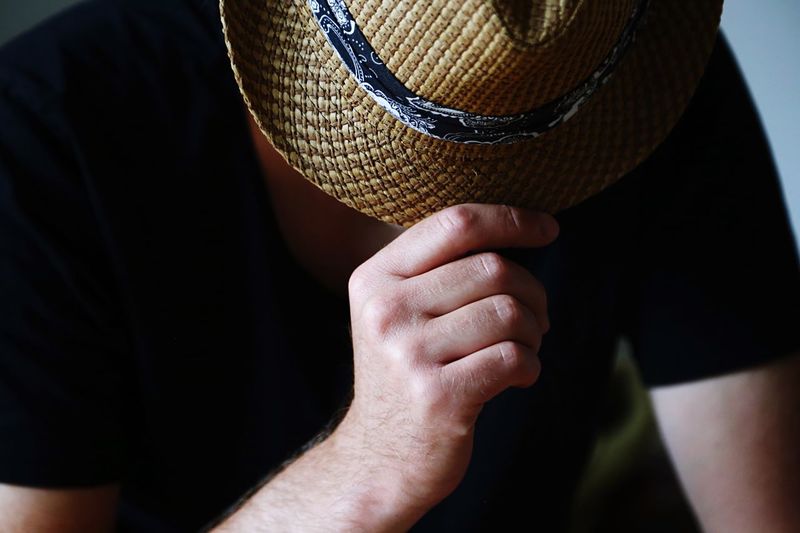 Close-up of man hand holding hat