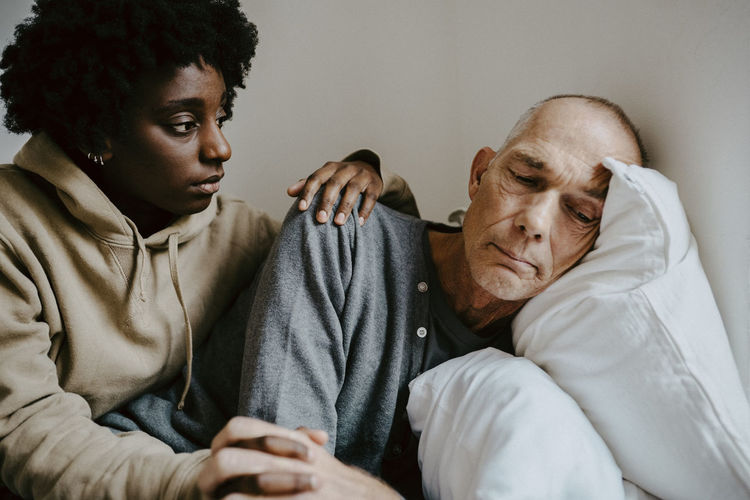 Daughter consoling worried father at home