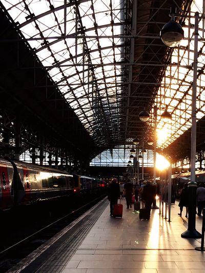 People waiting for train at piccadilly station during sunset