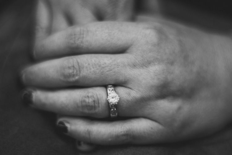 Cropped hands of woman wearing wedding ring