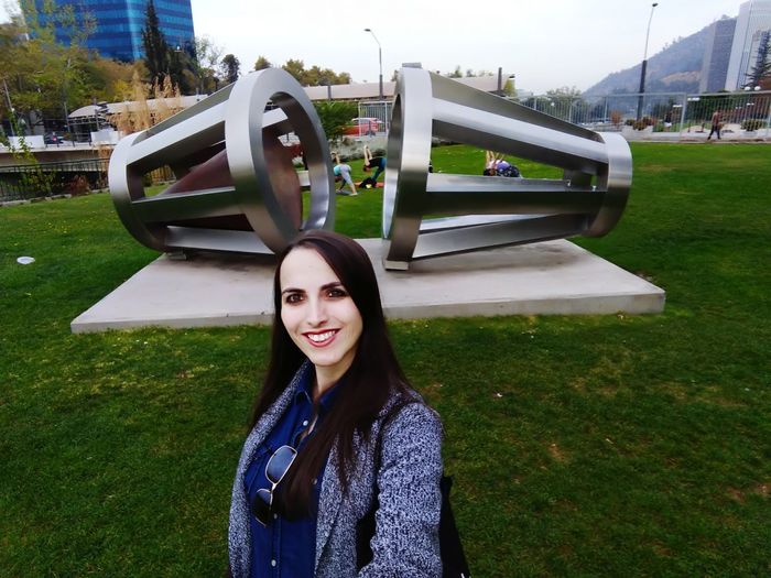 Portrait of smiling woman standing in park