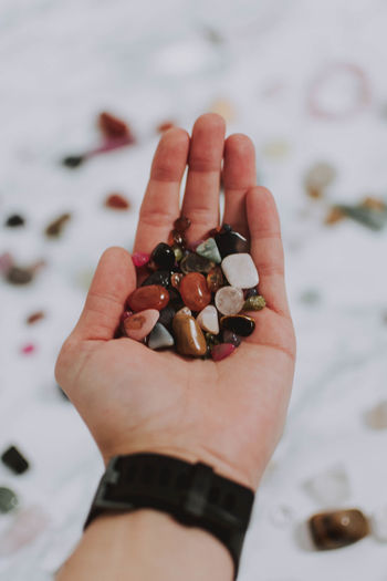 Close-up of hand holding pebbles