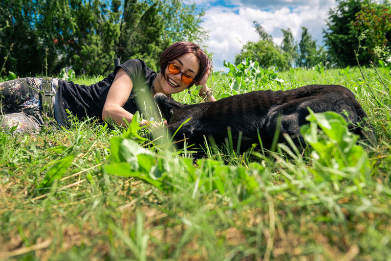 Portrait of woman sitting on grassy field