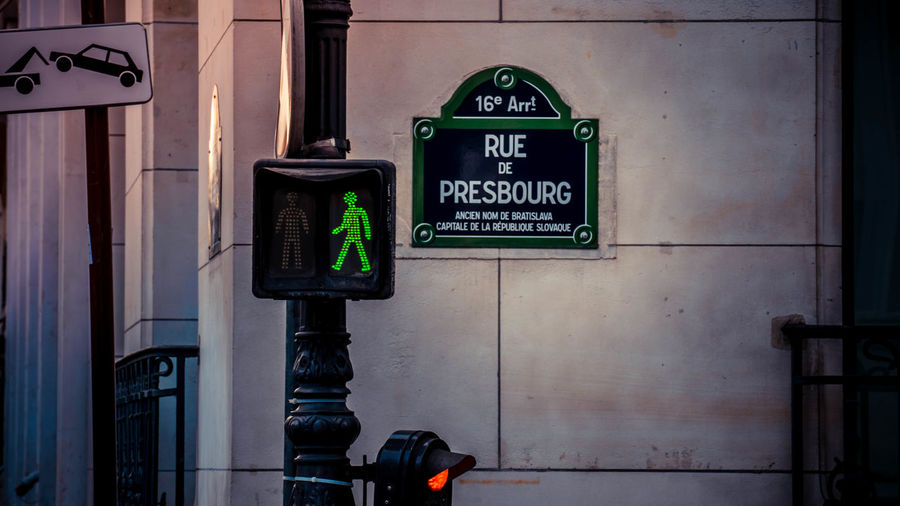 Close-up of information sign and trafficlight of paris