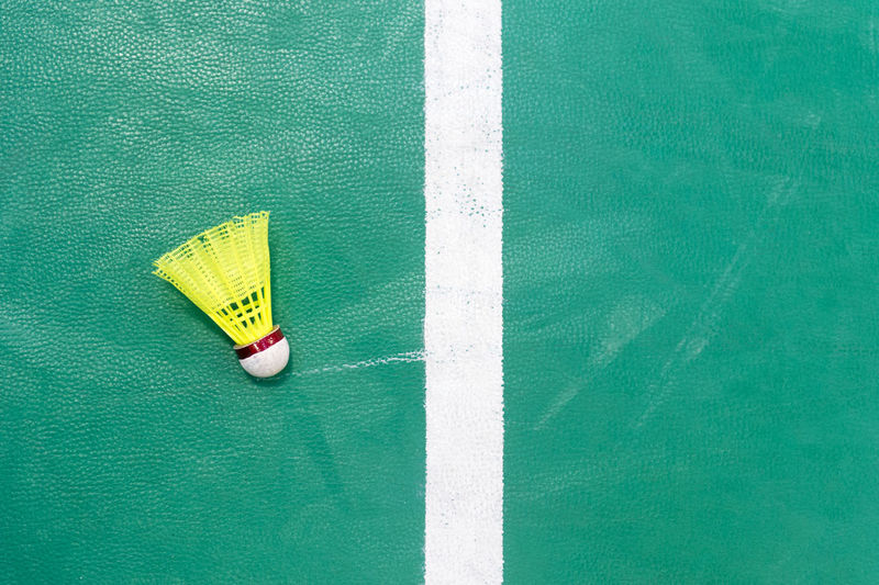 Directly above shot of shuttle cock on sports court