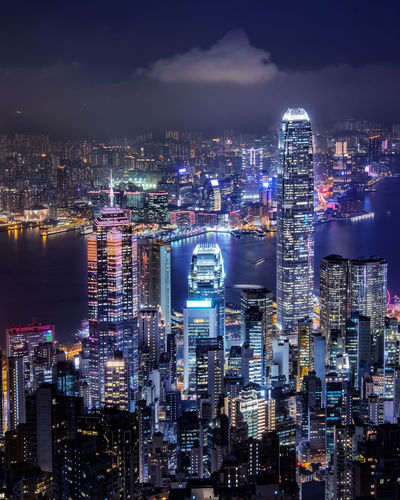 Illuminated cityscape against sky at night