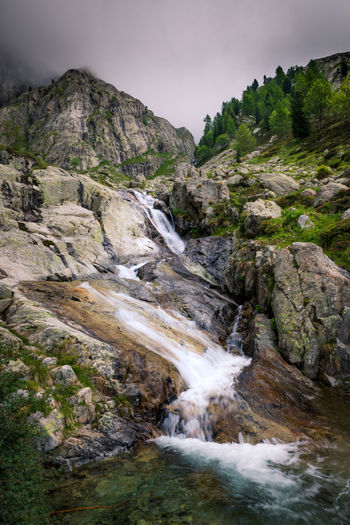 Scenic view of waterfall against sky
