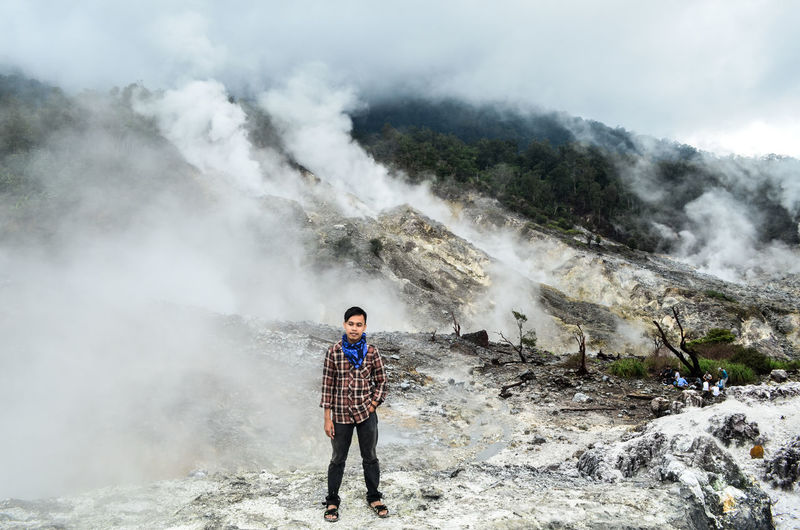 Full length of man standing at kawah ratu in taman nasional gunung halimun salak