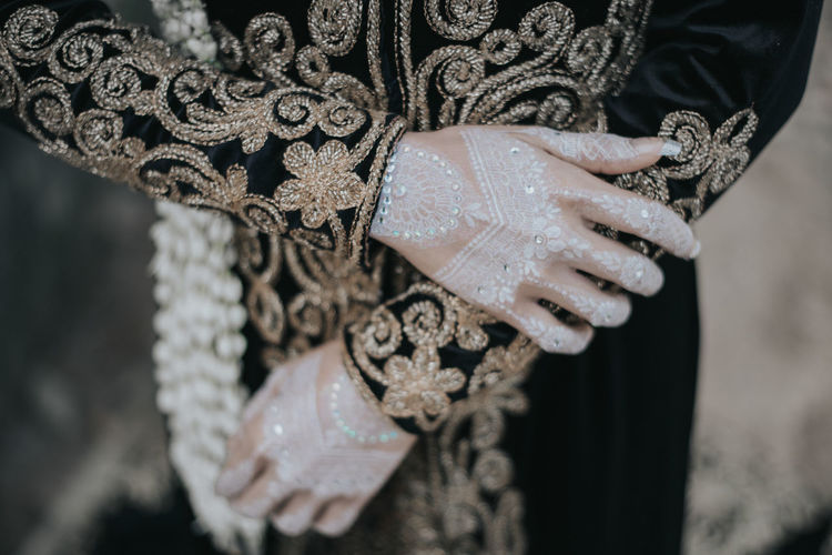 Close-up of woman holding hands against blurred background with java custom wedding