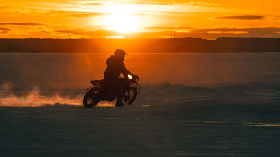 Man riding motorcycle on a  frozen lake