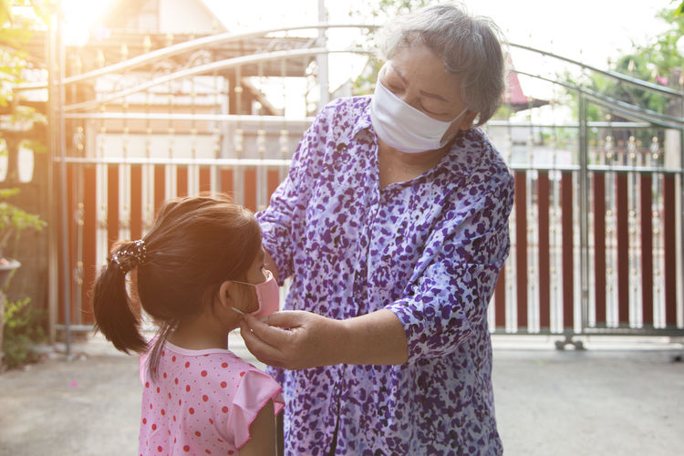 Grandparents take care her kids with face mask before out of home