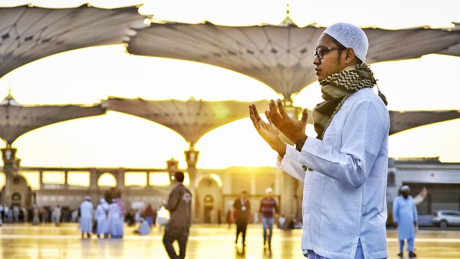 Muslim man praying during sunset