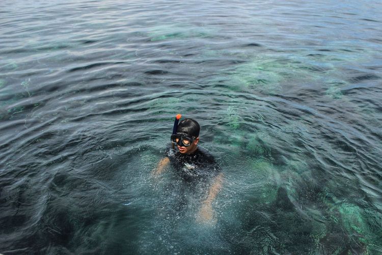 High angle view of man swimming in sea