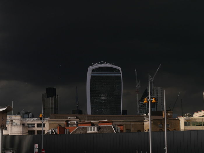 Illuminated cityscape against sky at night