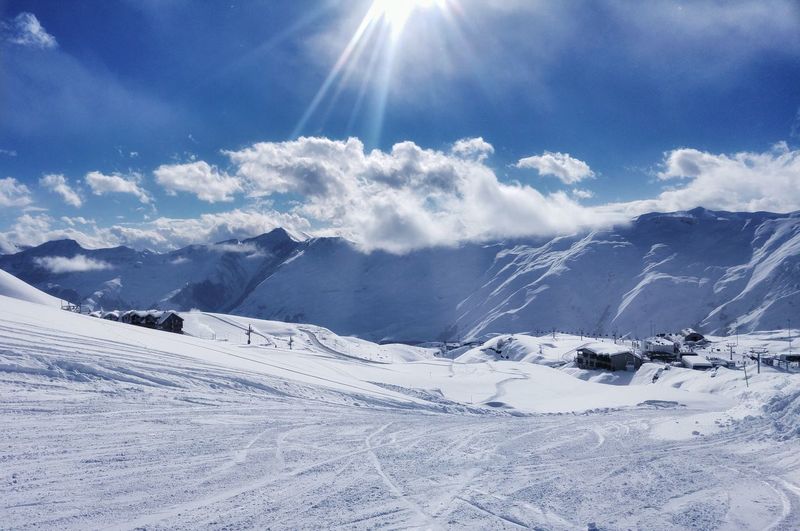 Scenic view of ski slope against sky