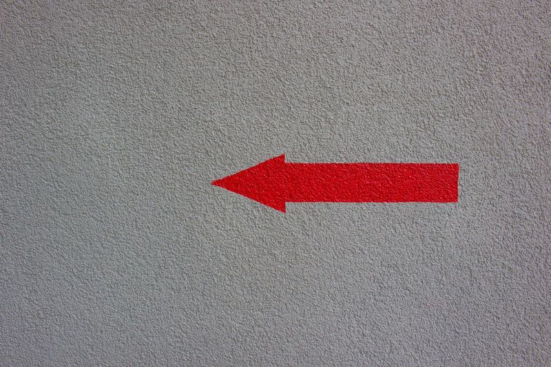 Red umbrella on brick wall