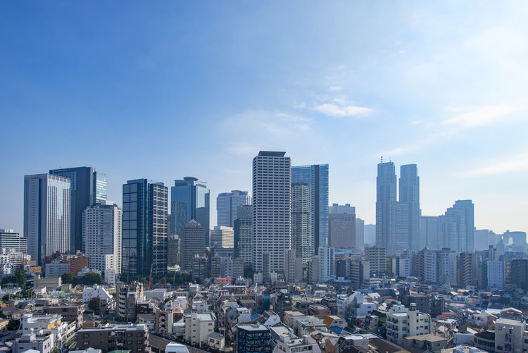 Aerial view of modern buildings in city against sky
