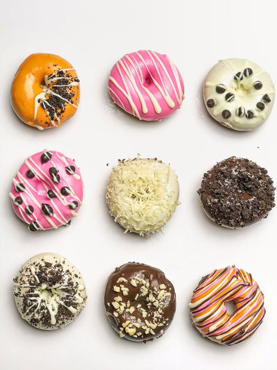 Close-up of multi colored candies against white background