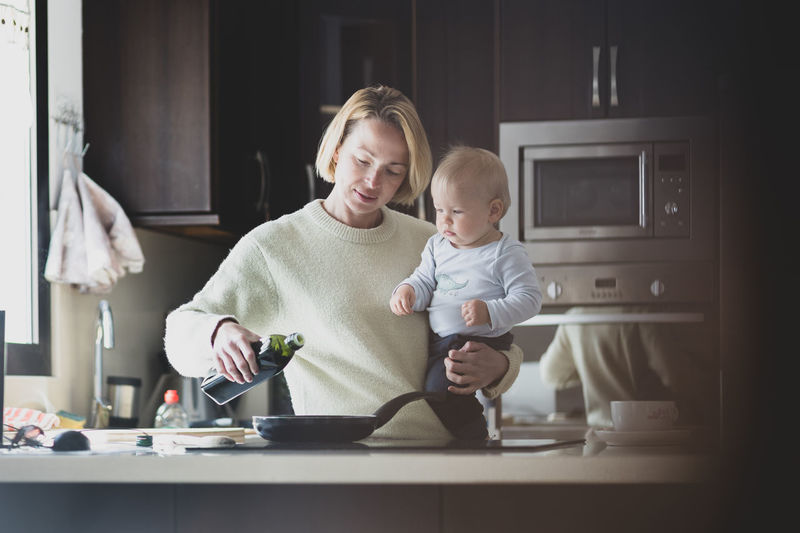 Portrait of smiling mother and daughter at home