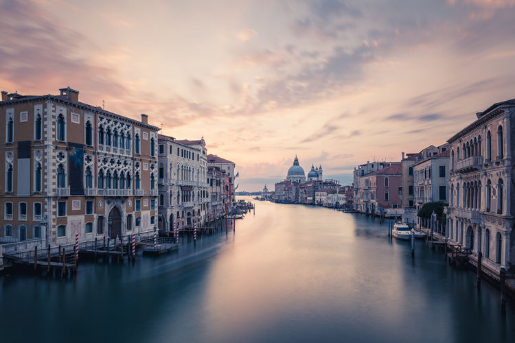 Grand canal against sky during sunset in city