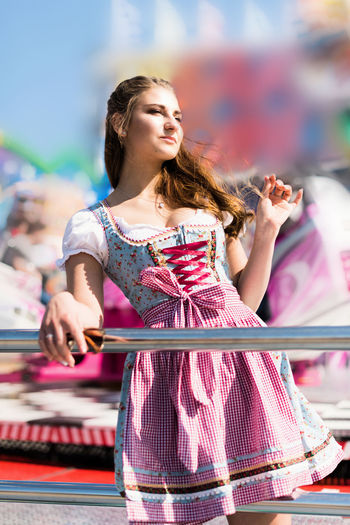 Young woman standing at amusement park