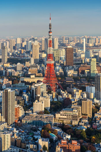 Tokyo tower against sky in city