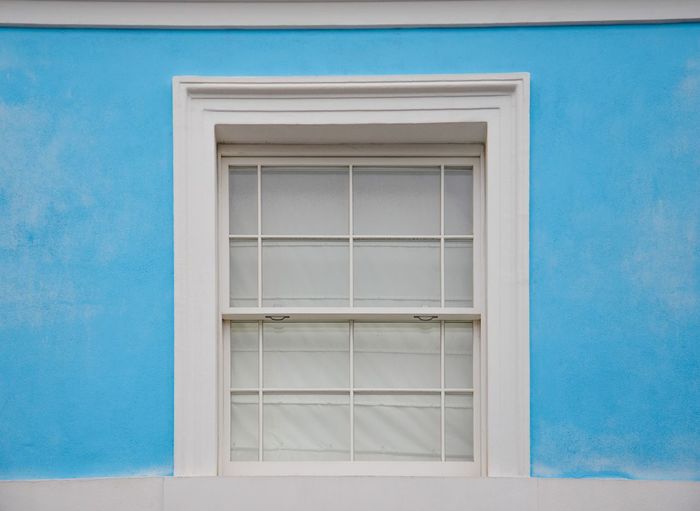 Closed window of blue building