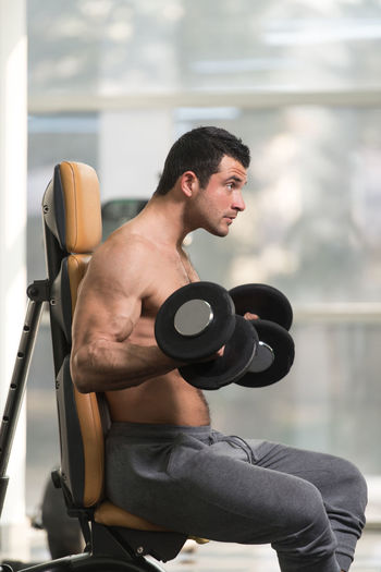 Muscular man exercising in gym
