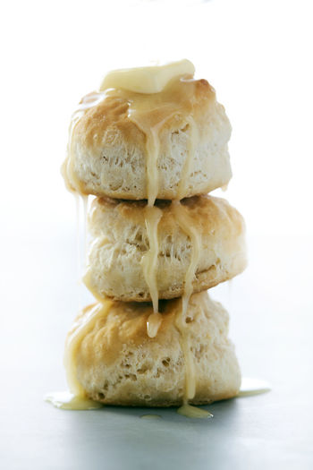 Stack of buttermilk biscuits with butter dripping