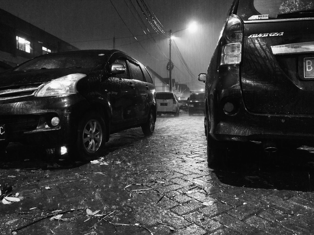 CARS ON WET STREET AT NIGHT