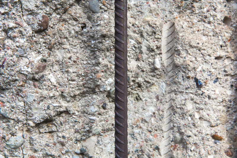 Close-up of metal rod on weathered wall