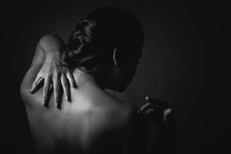 Close-up of woman touching back