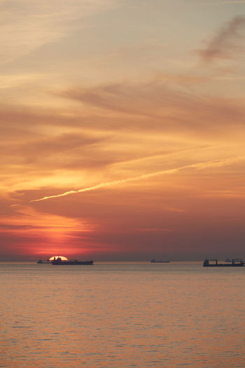 Scenic view of sea against romantic sky at sunset