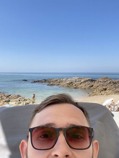 Portrait of man wearing sunglasses against clear sky