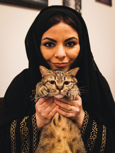 Portrait of woman with cat