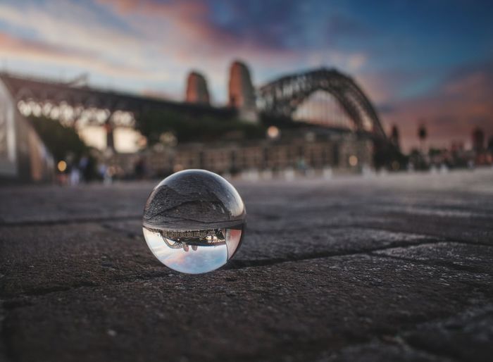 Close-up of crystal ball with sydney harbor bridge in background