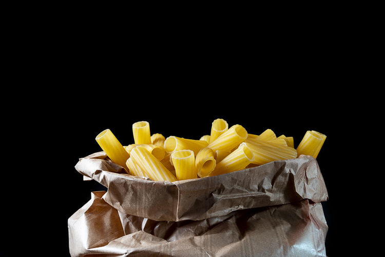 Close-up of fries against black background