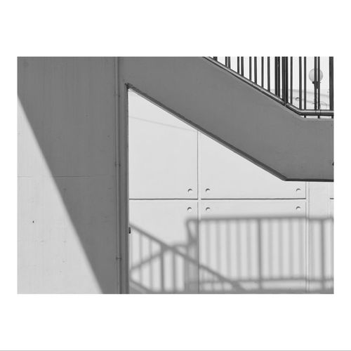 Shadow of railing on wall of building