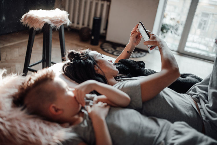Midsection of woman using mobile phone at home