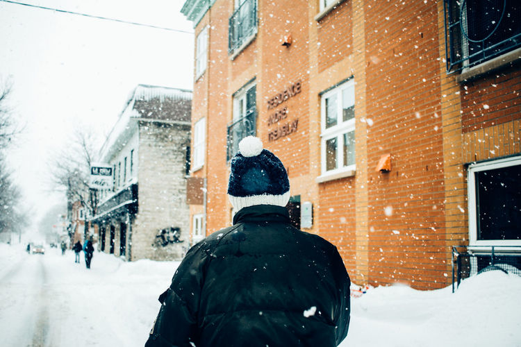 Rear view of man on snow in city