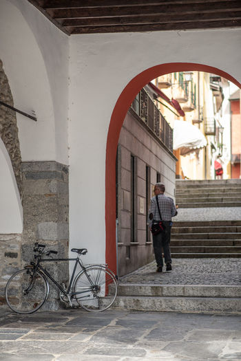 Rear view of man standing by building