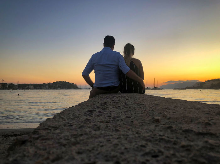 Couple watching the sunset at playa santa ponsa